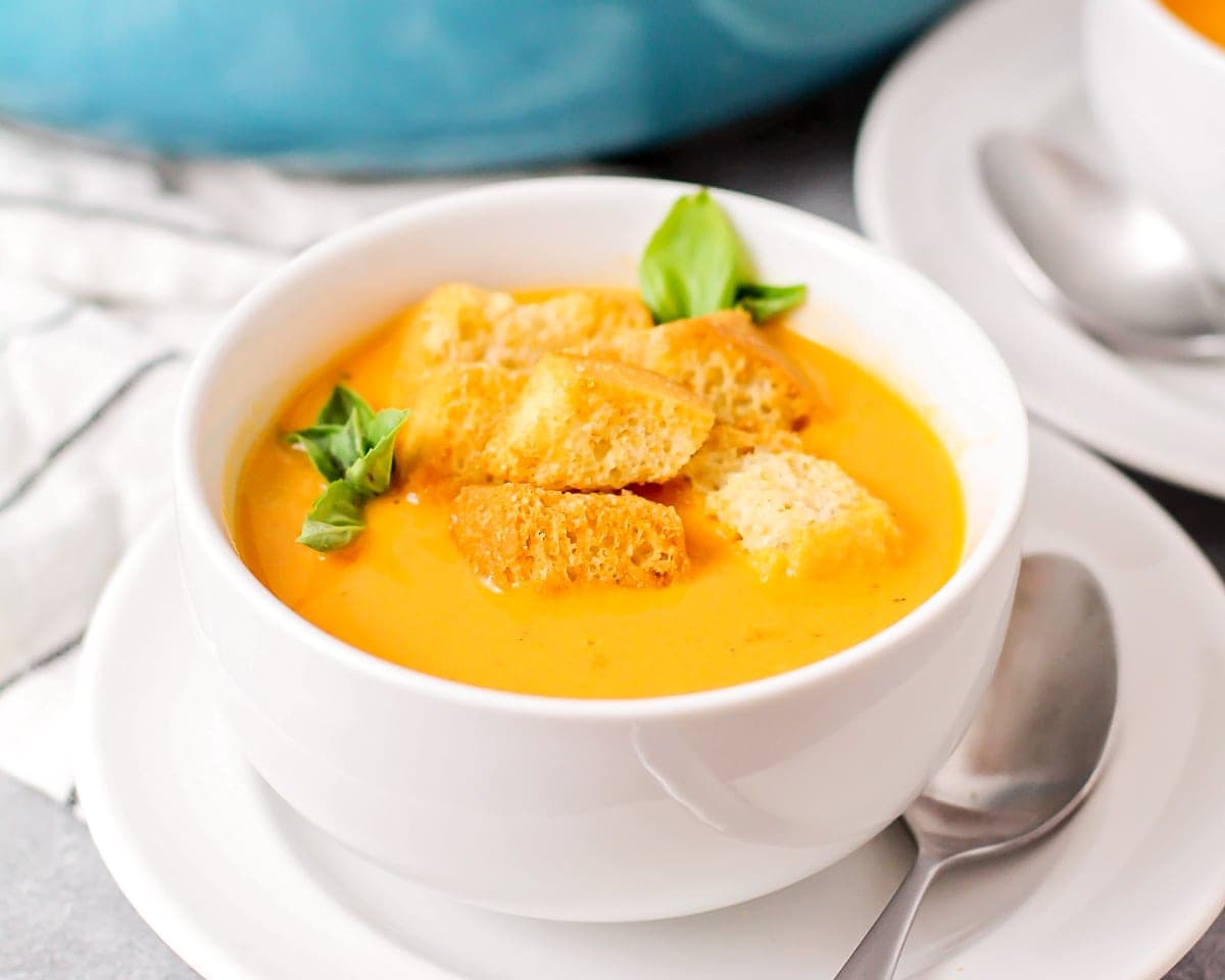 Roasted tomato soup served in a white bowl.