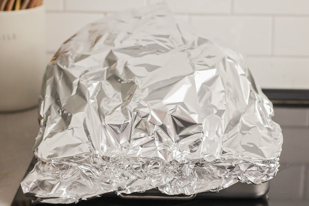 A roasted turkey covered in foil. 