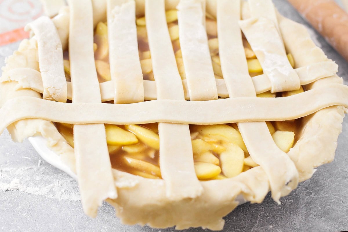 A process shot of making a lattice pie crust. 