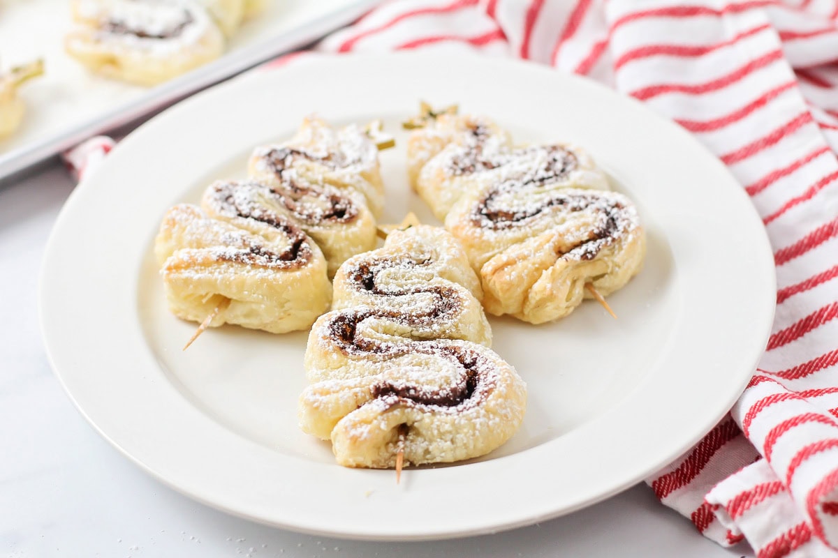 Three mini Nutella Christmas trees on a white plate.