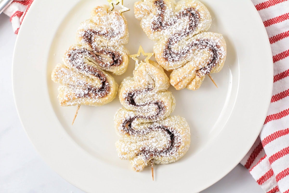 Three mini nutella Christmas trees on a white plate.