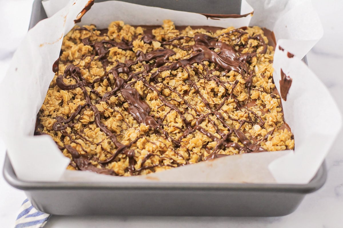 Chocolate drizzle over no bake chocolate oat bars.