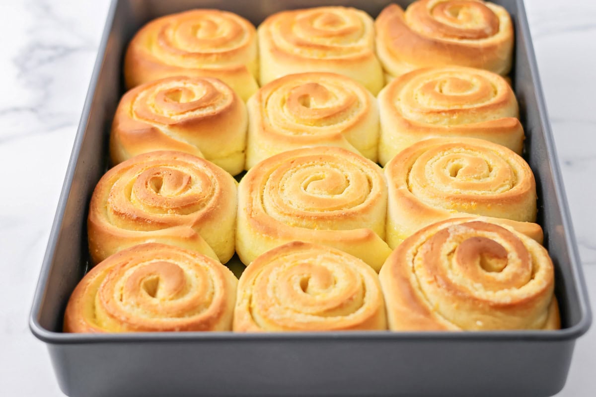 Filled with orange zest and smothered in an irresistible lemon frosting, these orange rolls are citrus-sweet roll heaven! Baked sweet rolls in a baking dish.