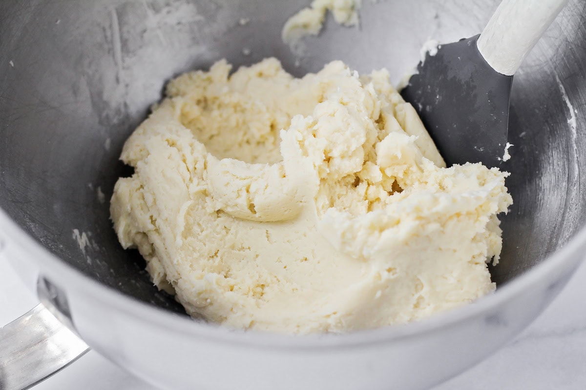 Cookie batter in a metal bowl.