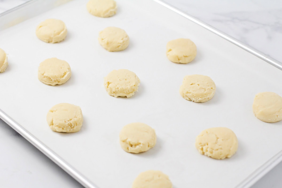 Baked cookies on a lined baking sheet.