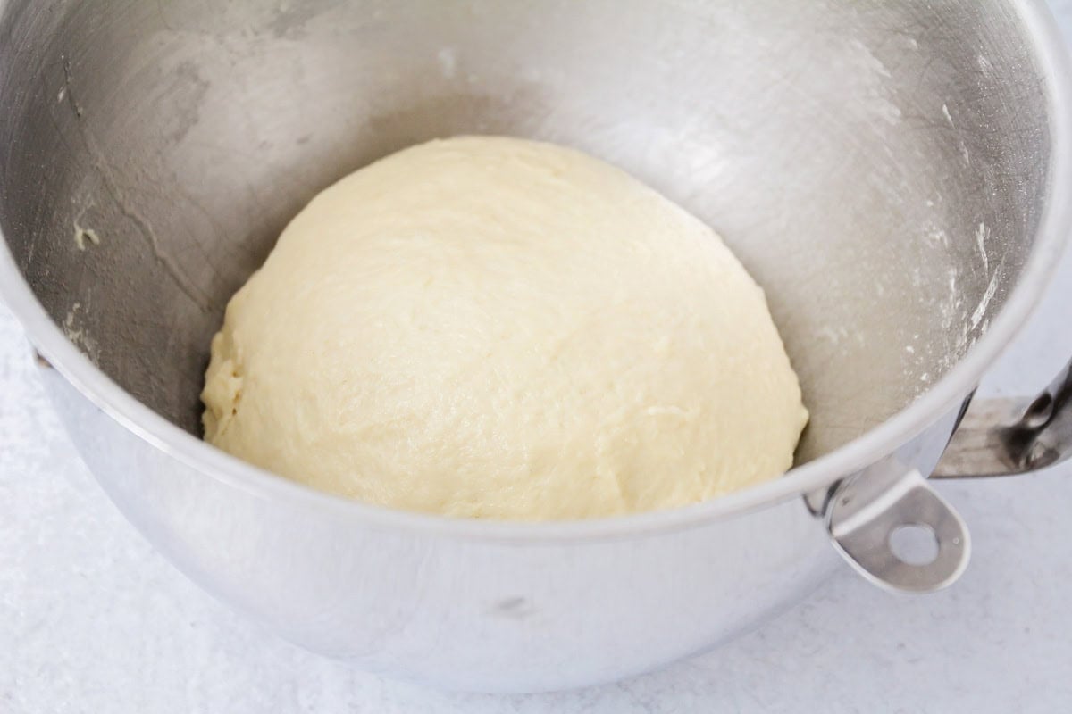 Potato rolls dough in kitchen-aid metal bowl.