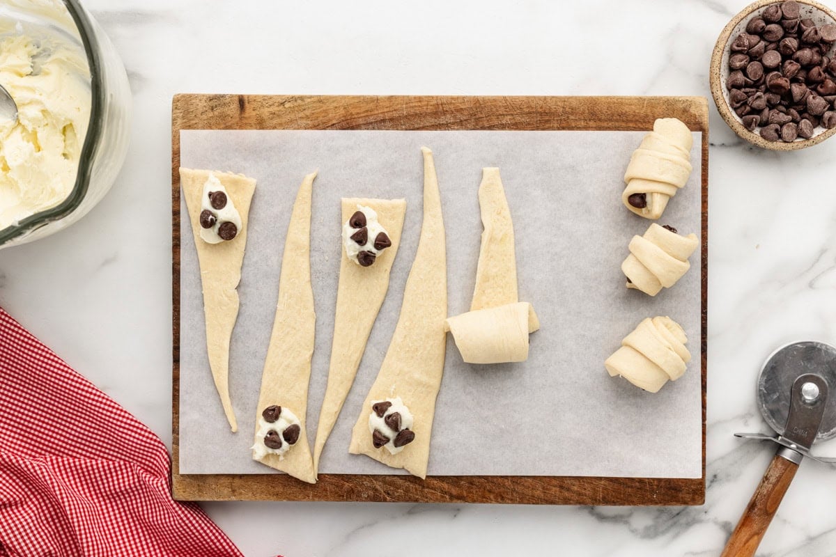 Rolling cheesecake filling and chocolate chips into the crescent roll dough.