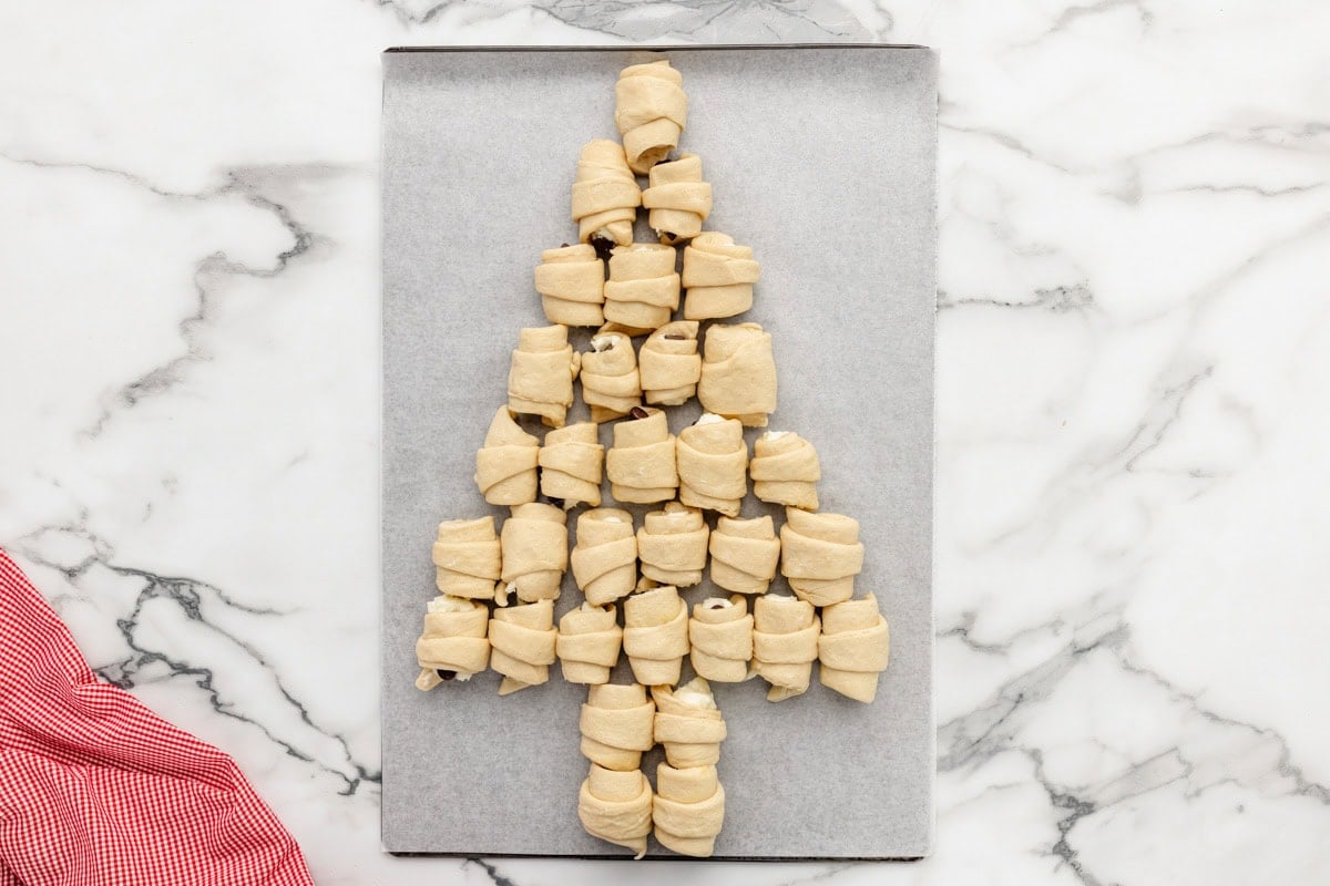 Several crescent rolls rolled and placed in a Christmas tree shape.