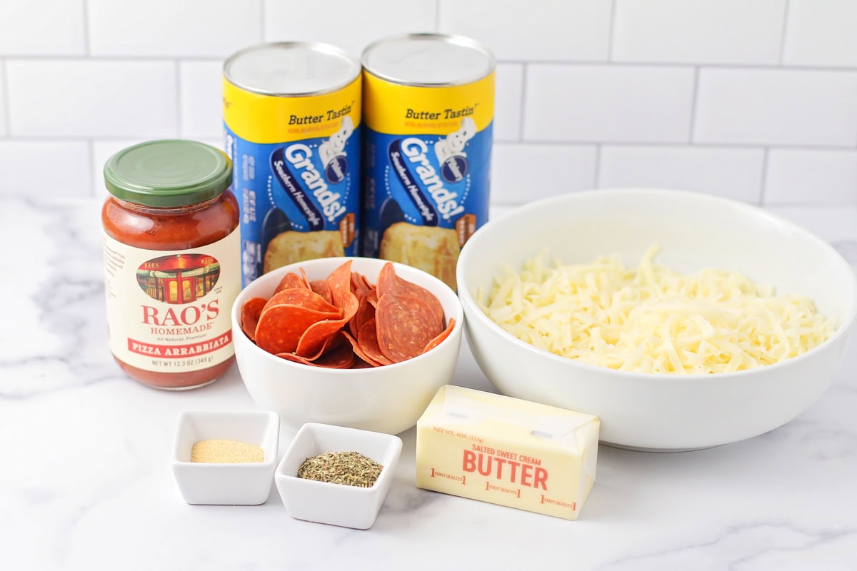 Ingredients for pull apart pizza bread on a kitchen counter.