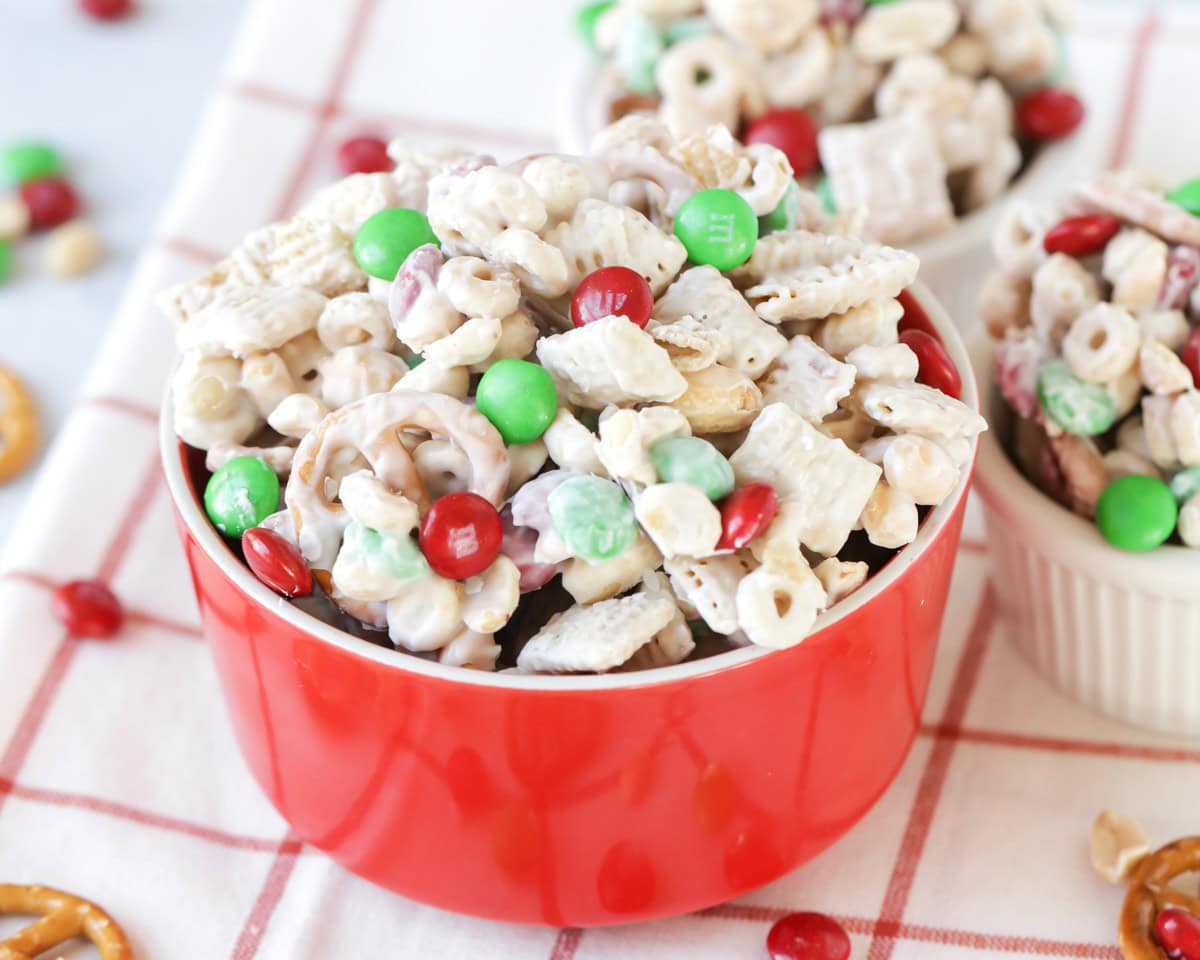 A red and white bowl filled with reindeer food recipe.