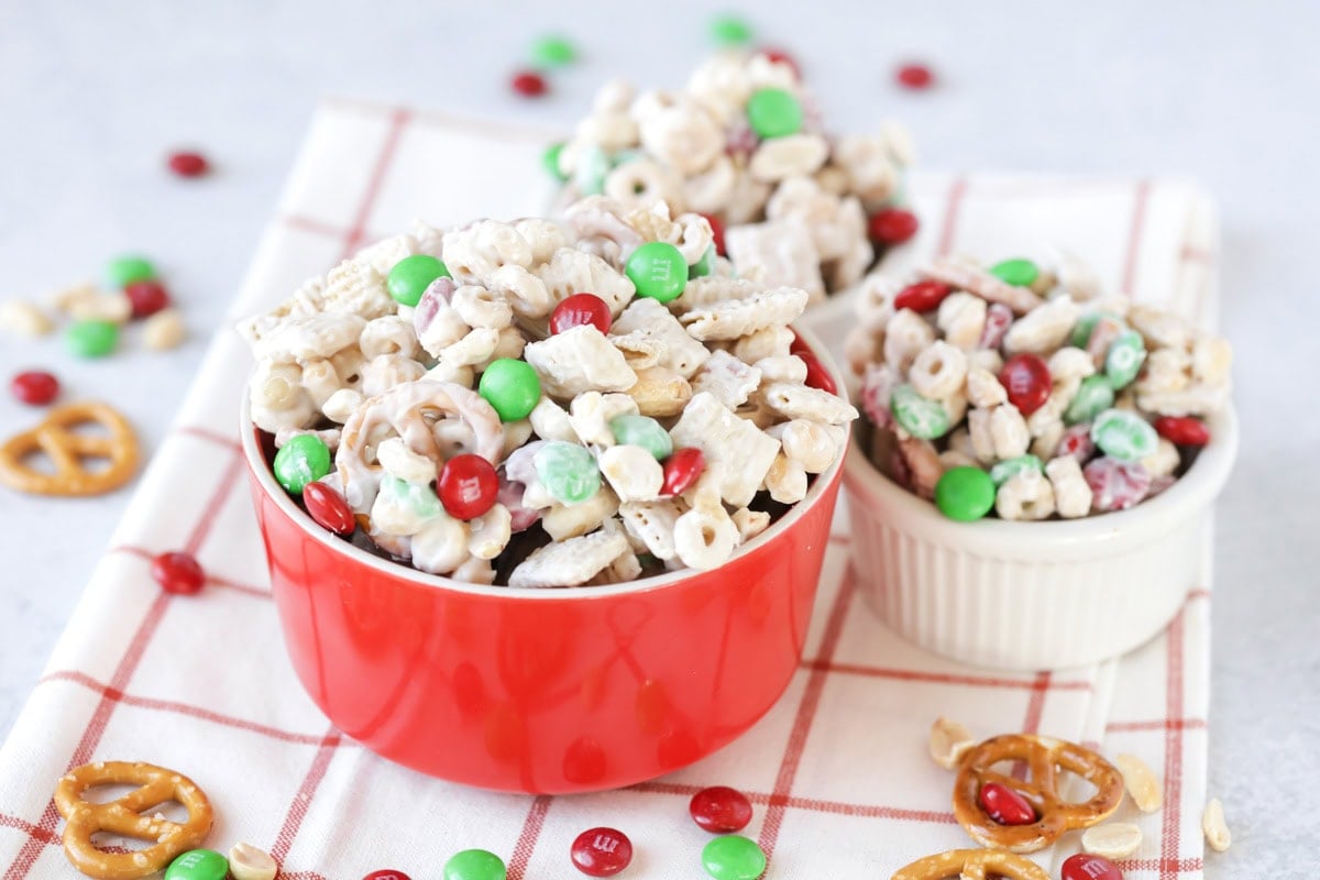 Red and white bowls filled with reindeer food recipe.