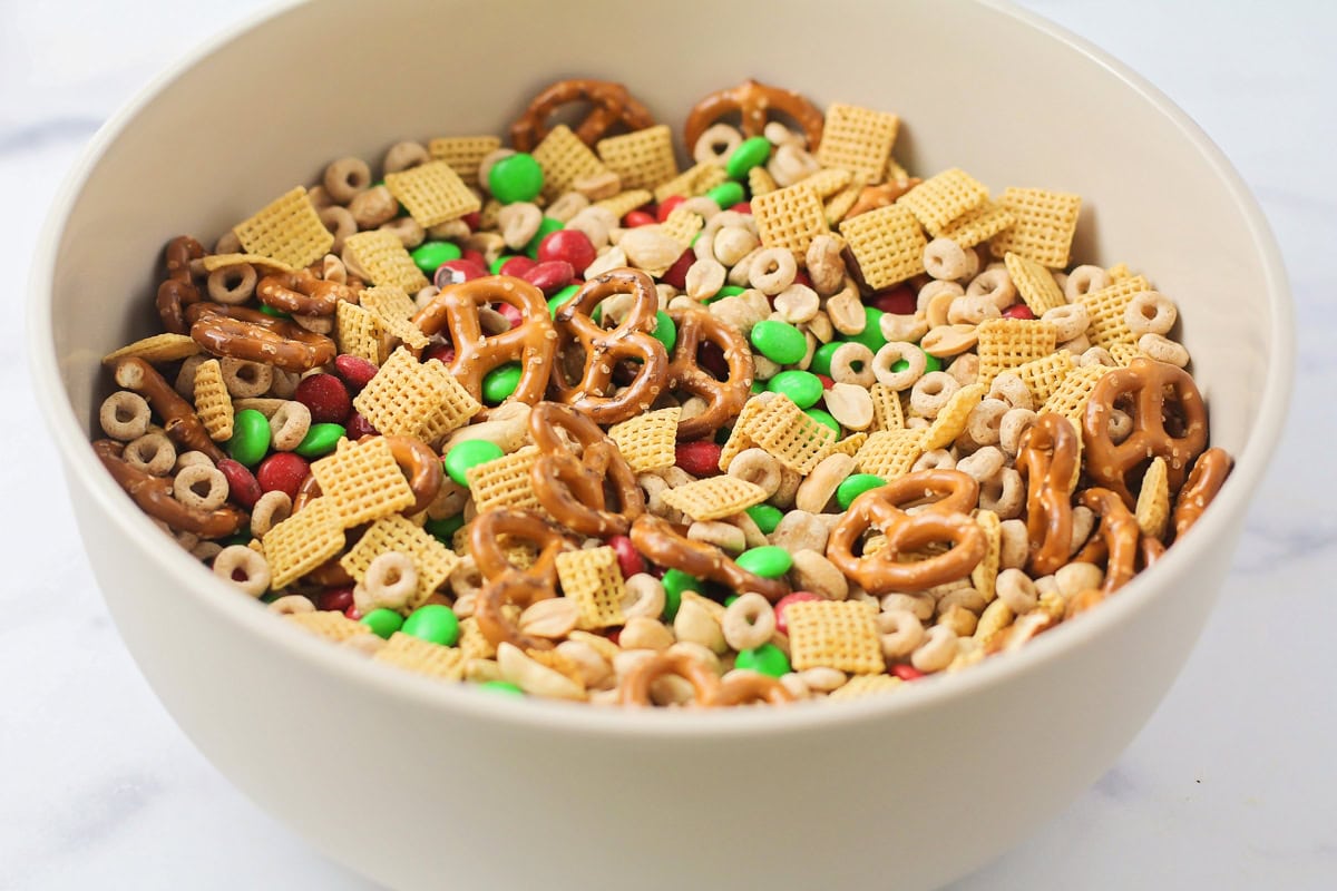 Cereal, nuts, pretzels, and M&Ms all mixed in a bowl.