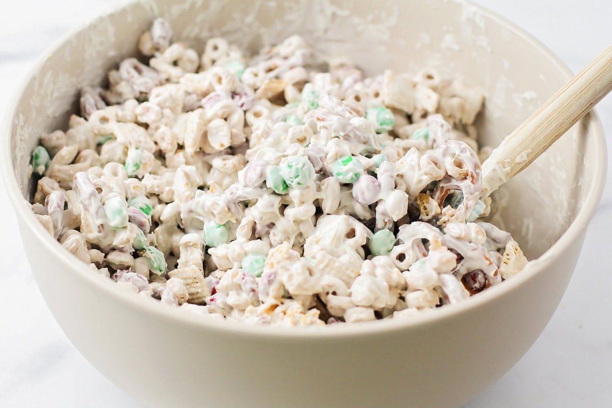 Stirring to coat the cereal mix in candy coating.