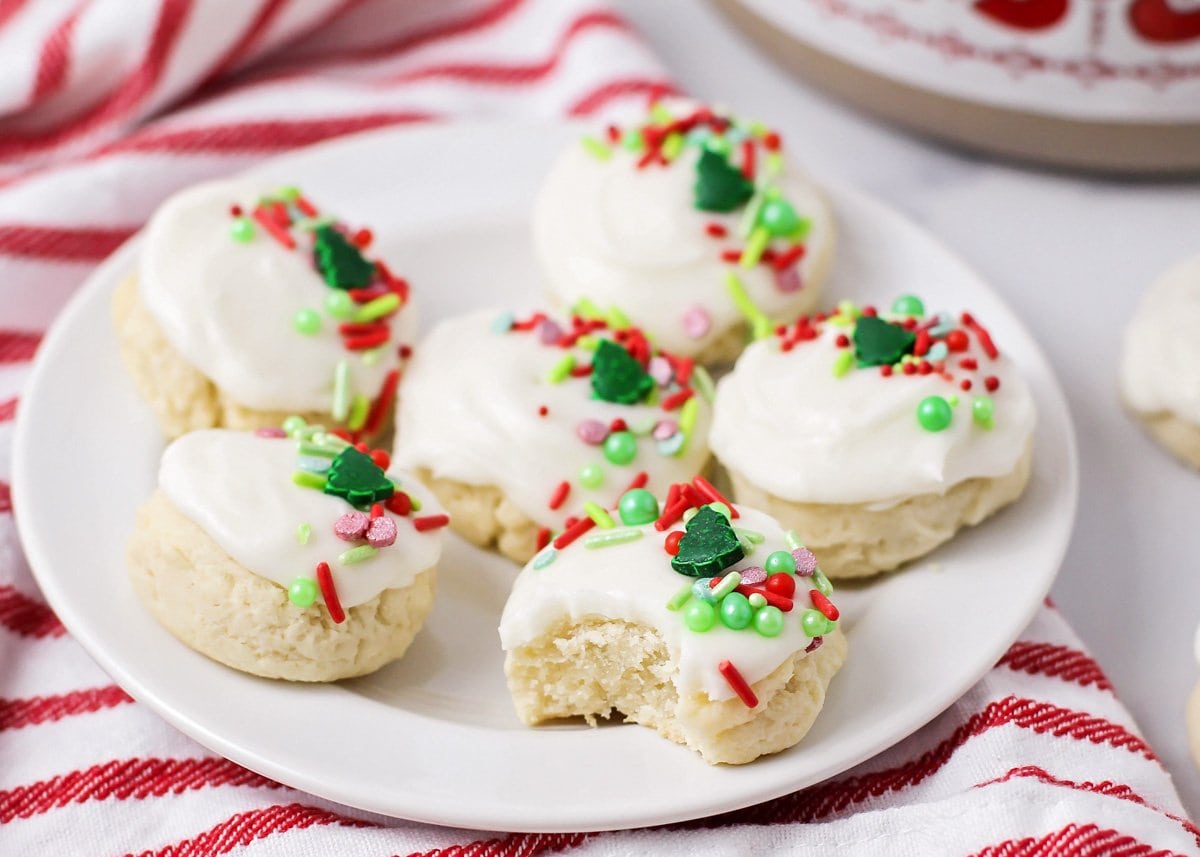 Close up of a plate of Santa cookies with one missing a bite.