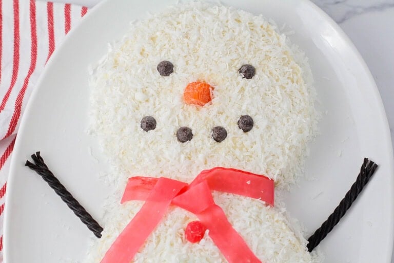 Snowman Cake close up image on white platter.