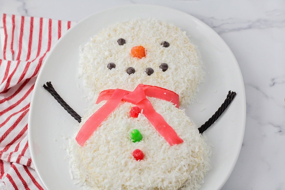 Close up of a decorated snowman cake.