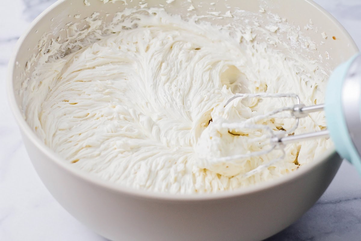 Whipping frosting in a gray bowl.