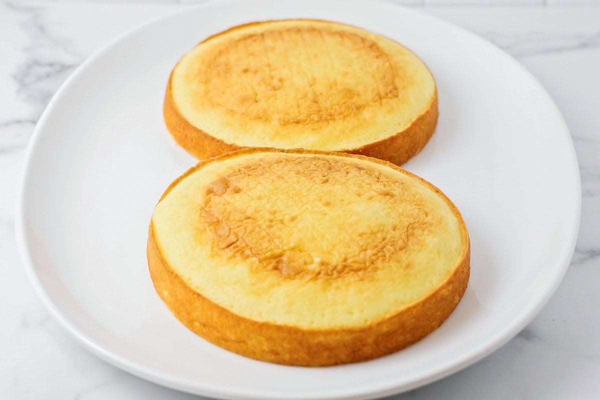 Two baked cakes on a white plate.