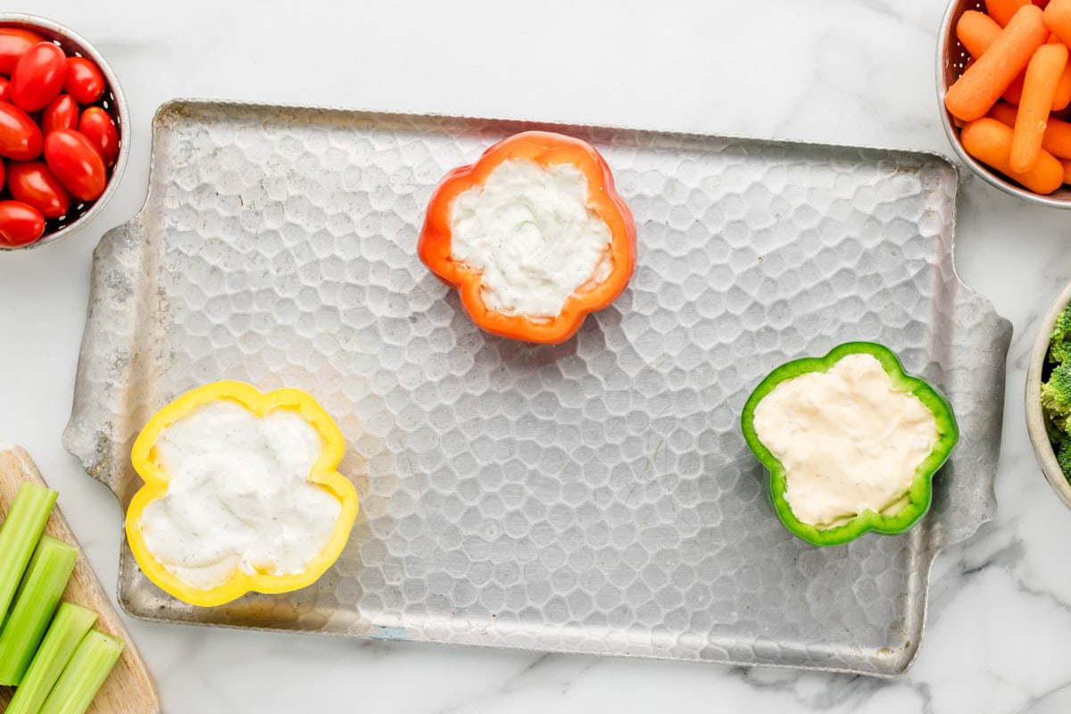 Dips poured into hollowed out bell peppers for veggie tray.