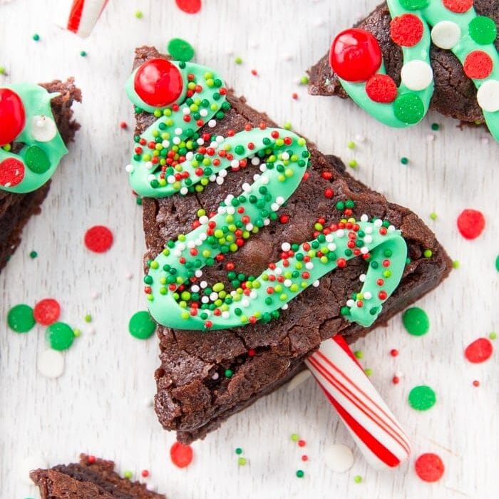 Decorated Christmas tree brownies on a kitchen counter.