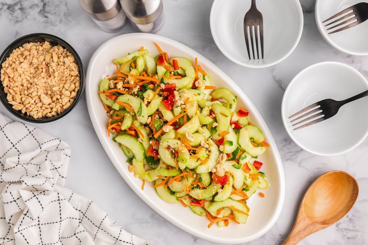 A white bowl filled with Asian cucumber salad.