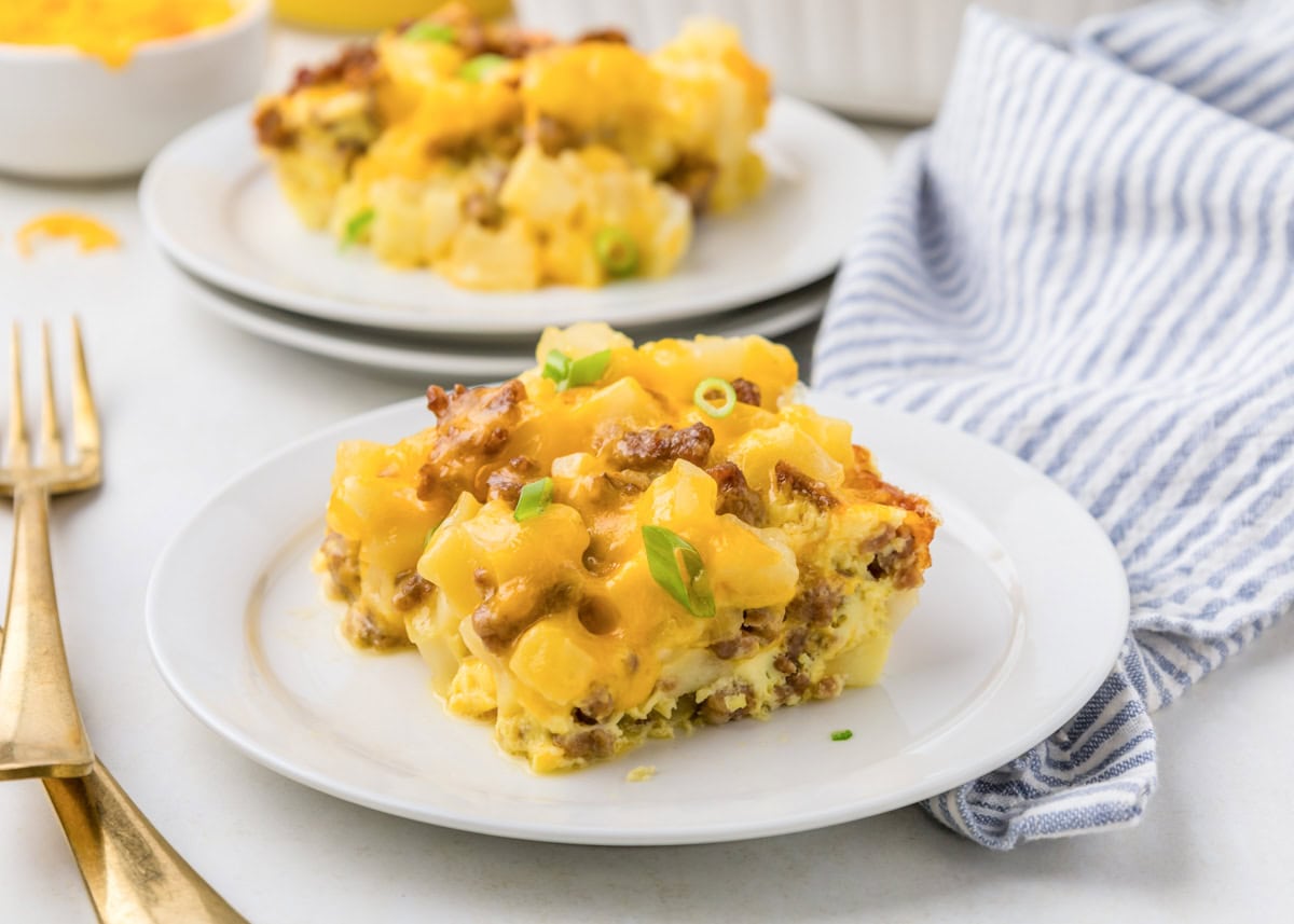 Slice of breakfast potato casserole on white plate.