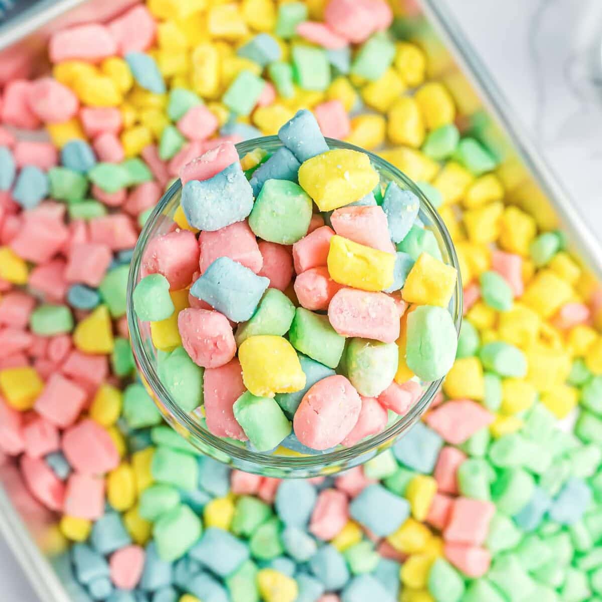 Homemade butter mints in glass cup.