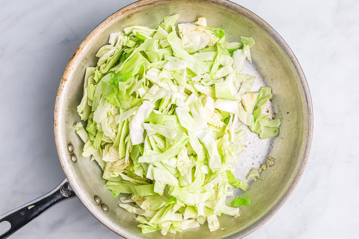 Sliced cabbage in a pan with garlic.