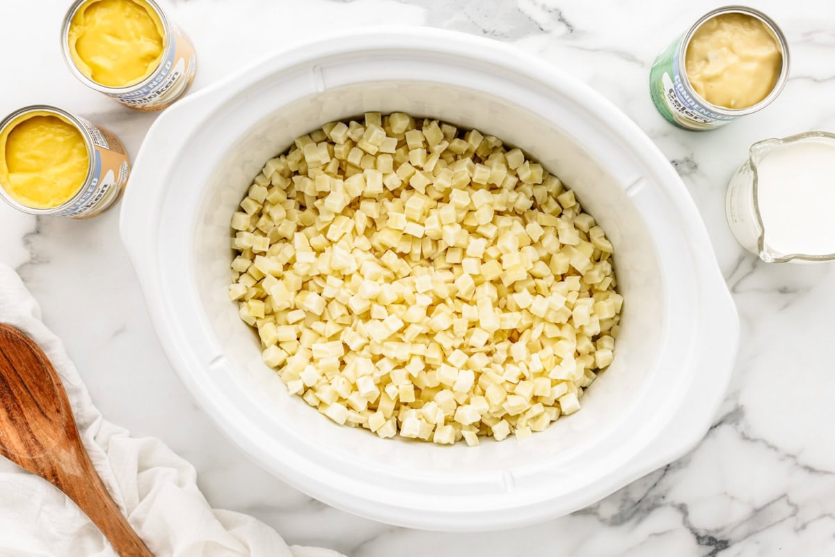 Diced hash browns in slow cooker for cheesy potato soup.