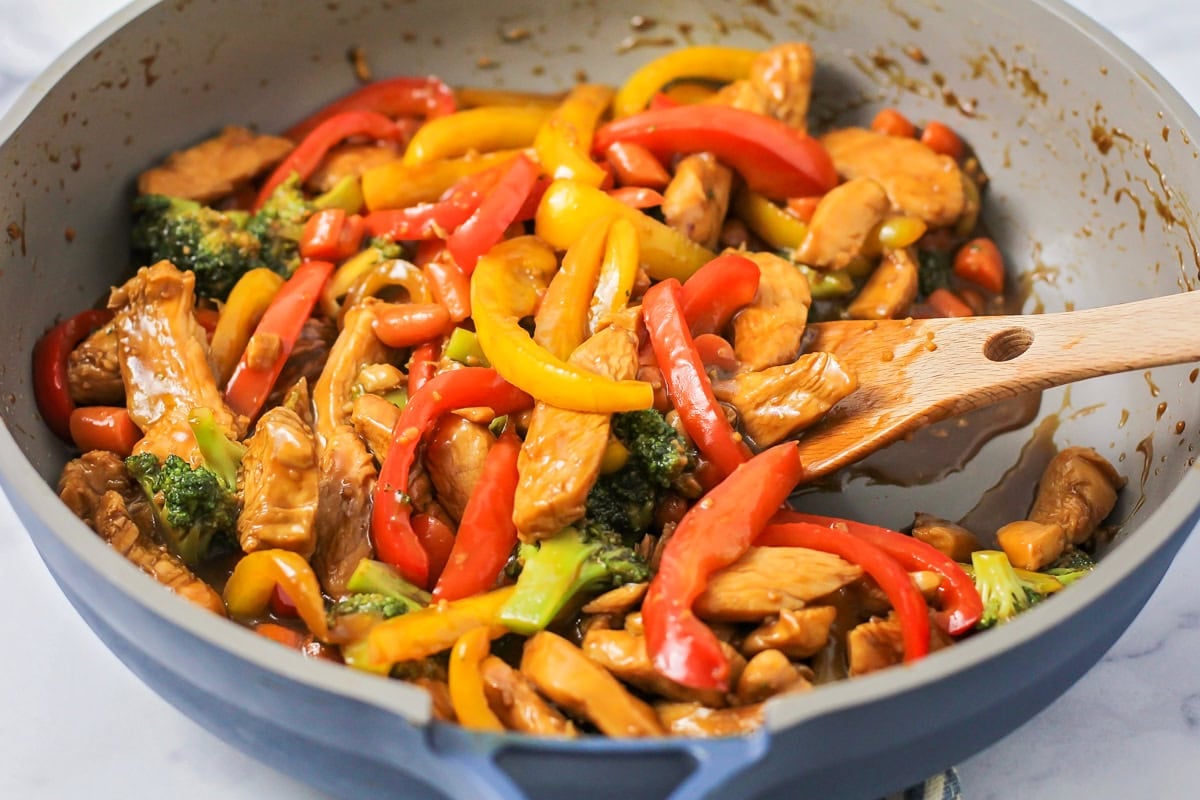 Chicken stir fry in a skillet.