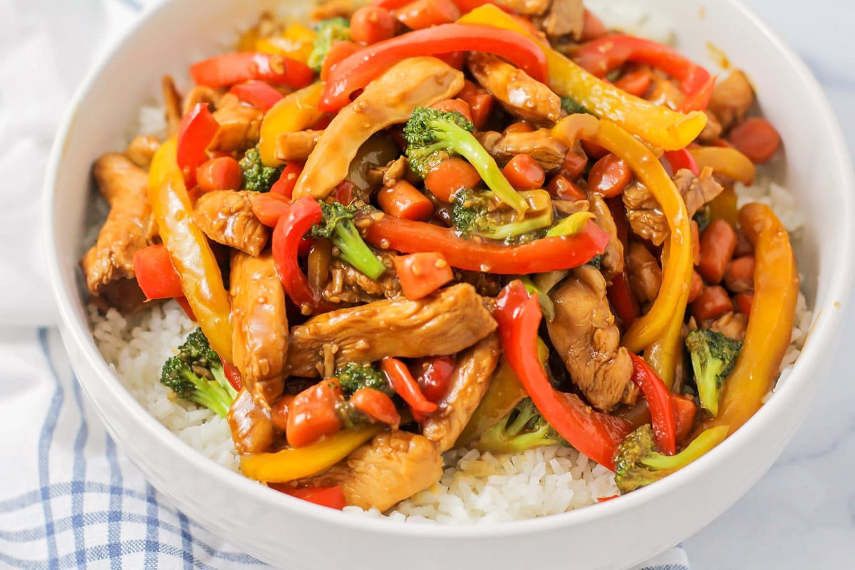 Chicken stir fry served over a bed of rice.