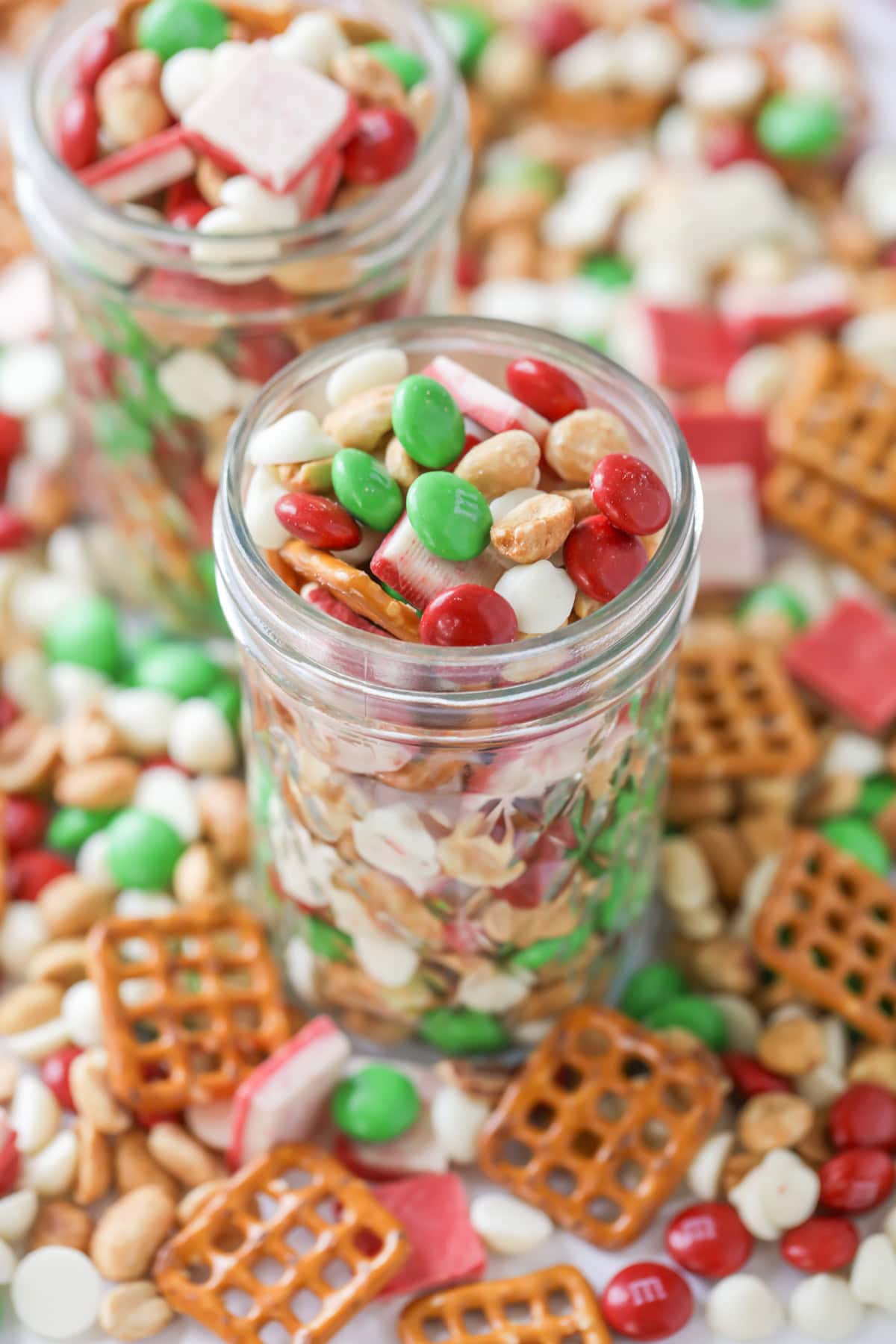 Christmas snack mix in jar with the mix spread all over.