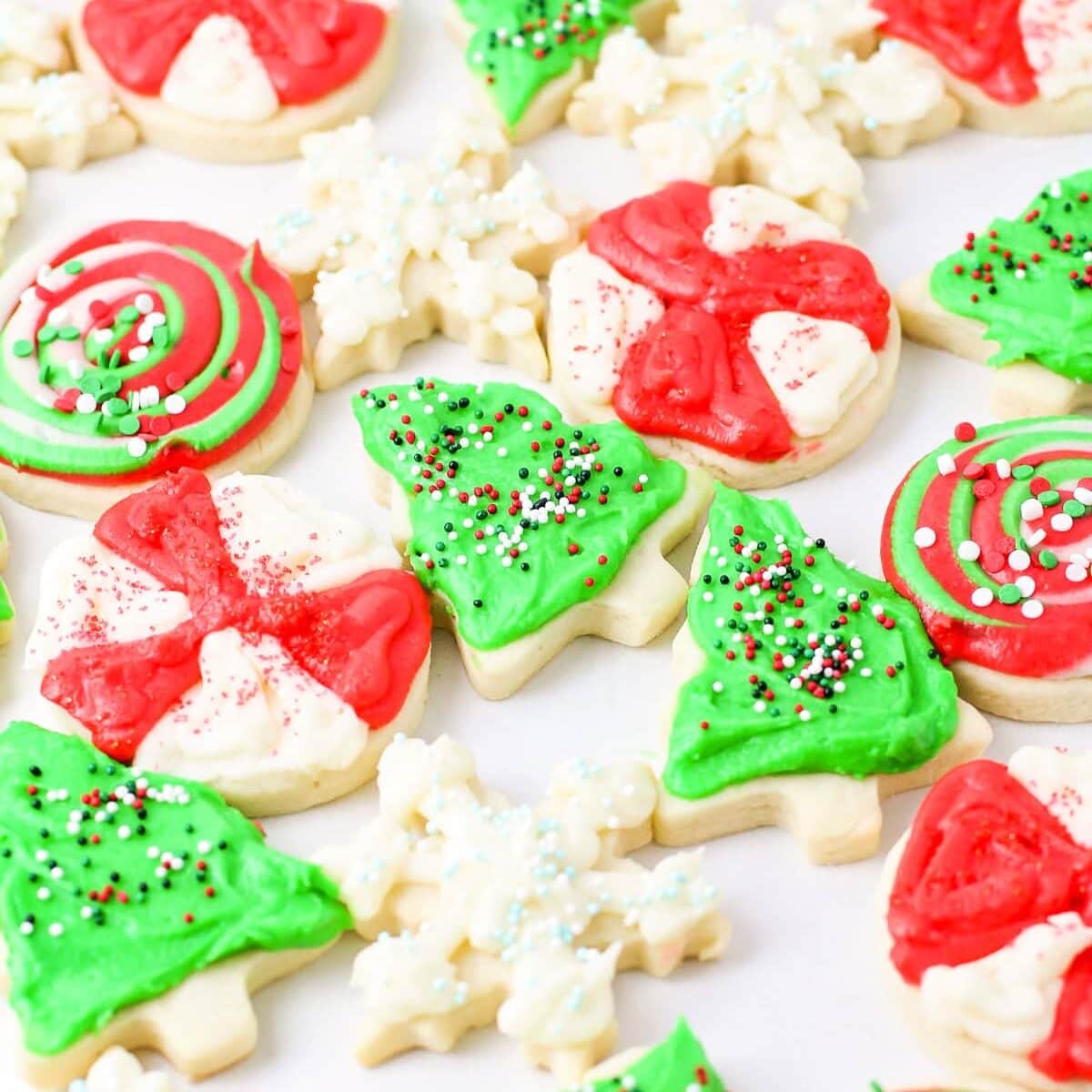 A baking sheet covered in frosted Christmas sugar cookie recipe.