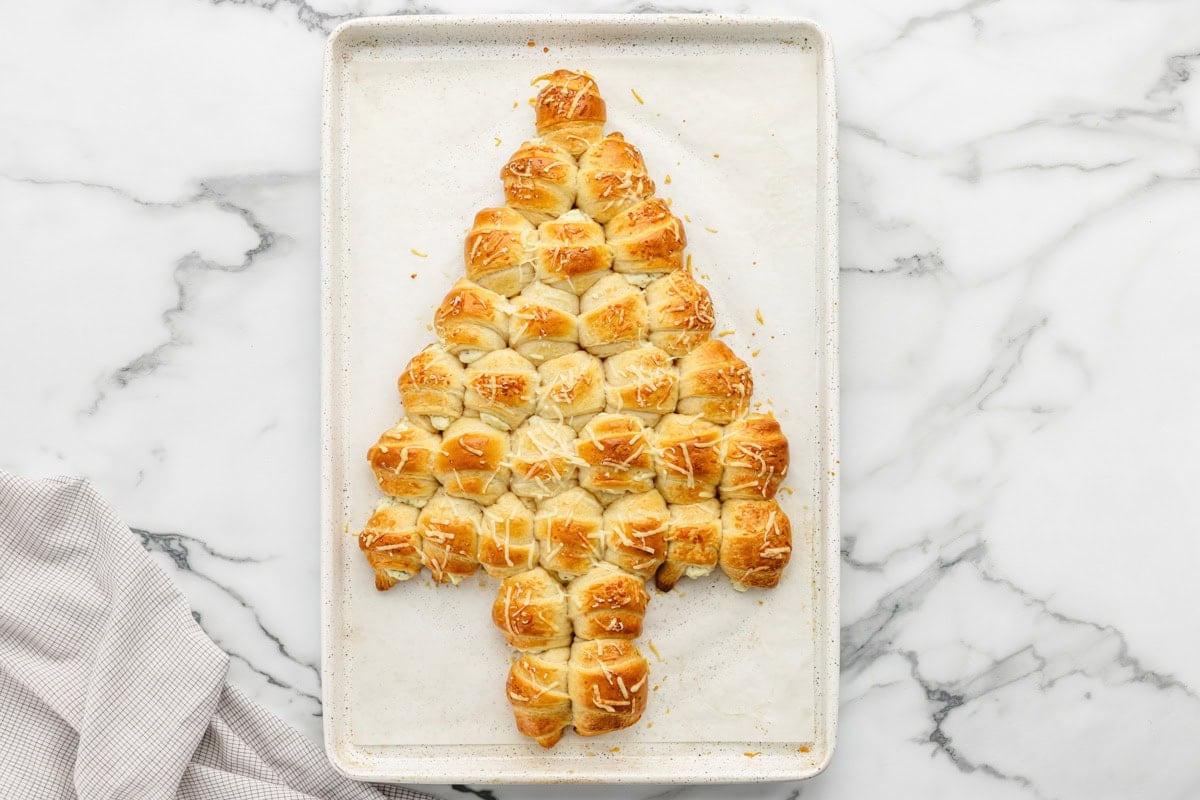 Baked crescent roll Christmas tree on baking sheet.