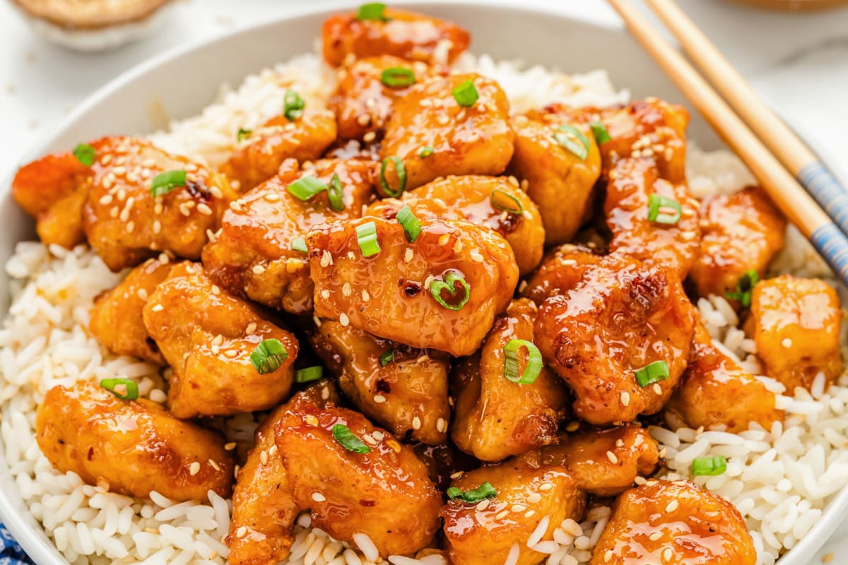 Close up of firecracker chicken served over a bed of rice.