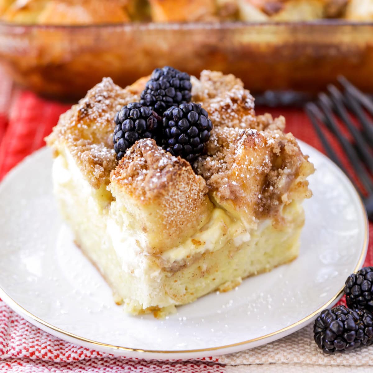 French toast casserole with cream cheese slice on white plate.