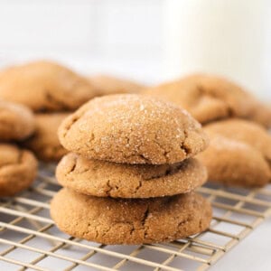 Gingerdoodles stacked on top of each other on cookie tray.