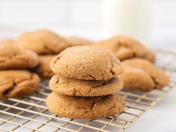 Gingerdoodles stacked on top of each other on cookie tray.