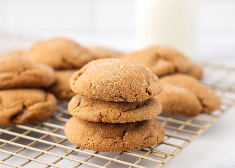 Gingerdoodles stacked on top of each other on cookie tray.