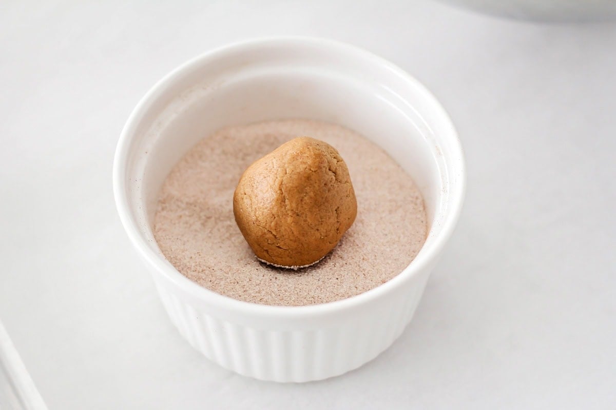 Super soft gingerdoodle cookies are perfectly spiced and coated in a cinnamon sugar mixture for two tasty cookies in one! Rolling a cookie dough ball in a cinnamon sugar mixture.