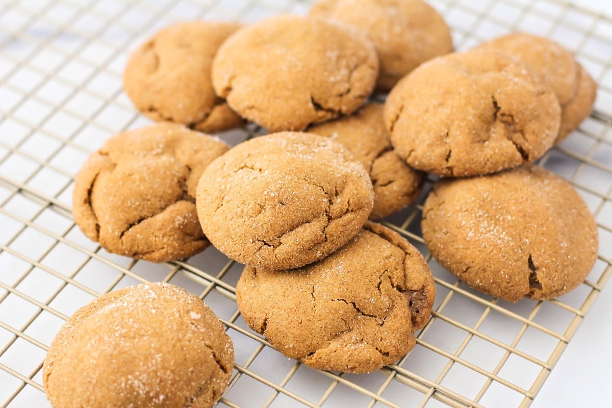 Super soft gingerdoodle cookies are perfectly spiced and coated in a cinnamon sugar mixture for two tasty cookies in one! A pile of cooled gingerdoodles on a wire rack.