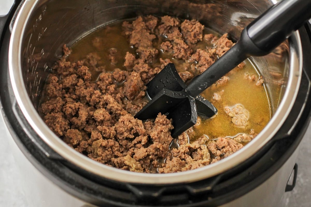 Breaking up ground beef in an instant pot.