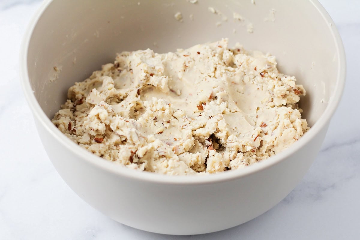 Cookie batter mixed in a grey bowl.