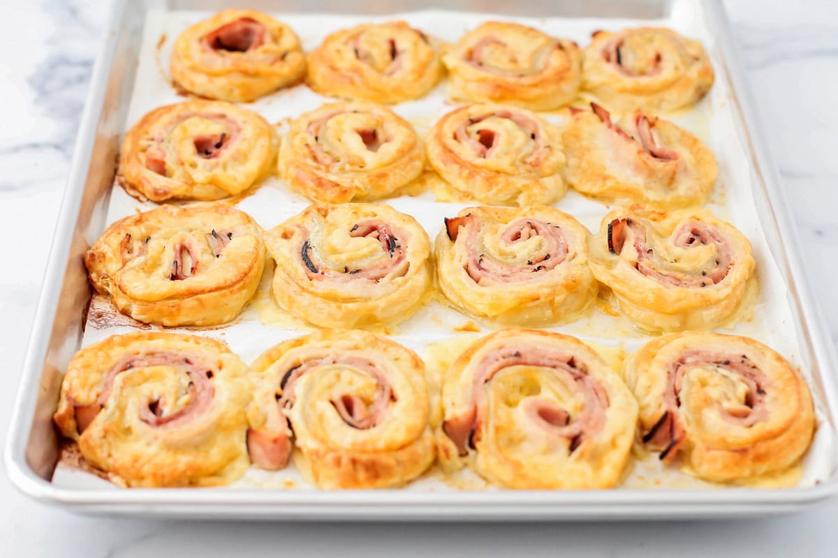 Baked monte cristo pinwheels on a baking sheet.