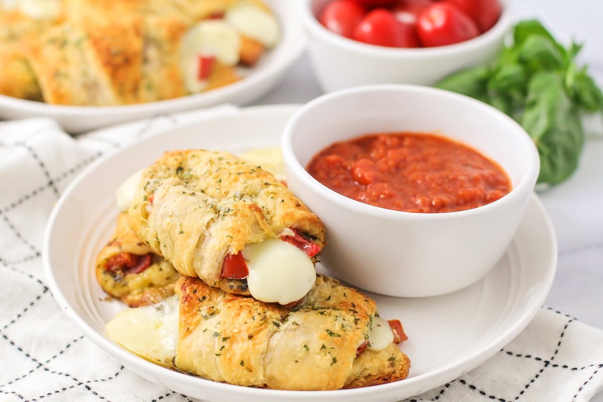 Three pesto caprese croissants served with marinara.