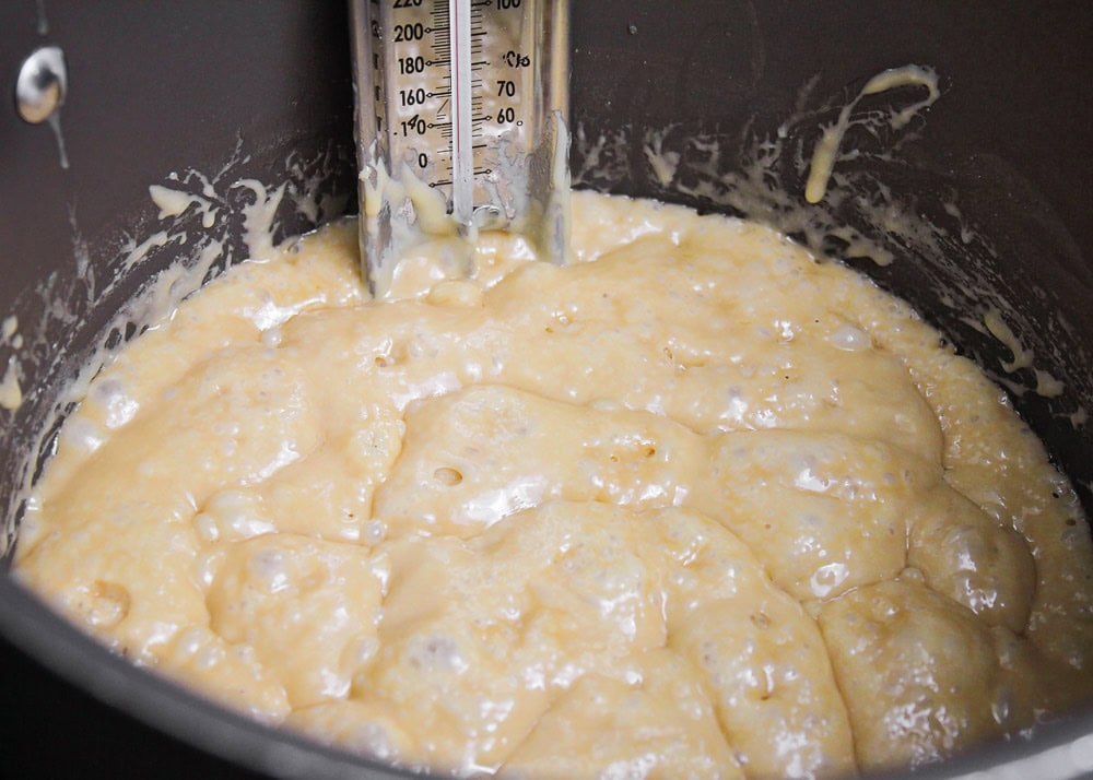 Butter and brown sugar boiling in pot for pretzel toffee recipe.