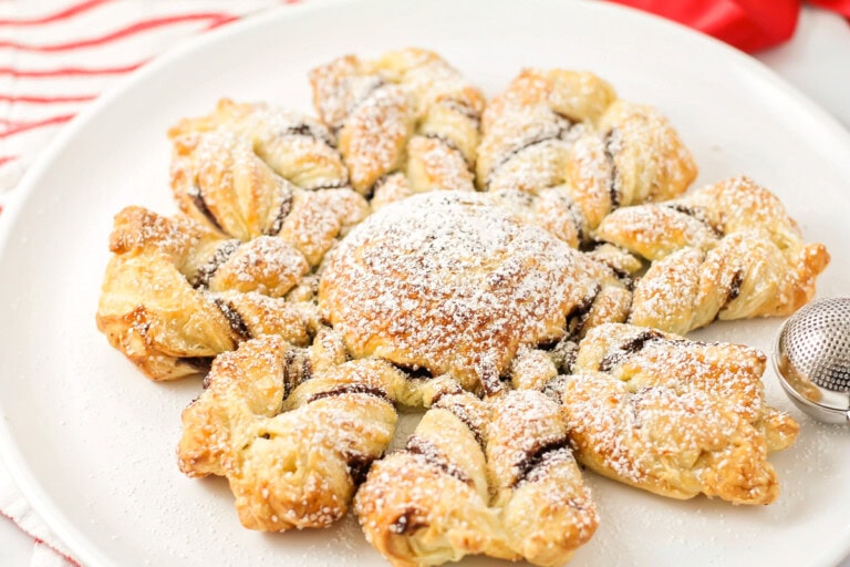 Puff pastry snowflake dusted in powdered sugar.
