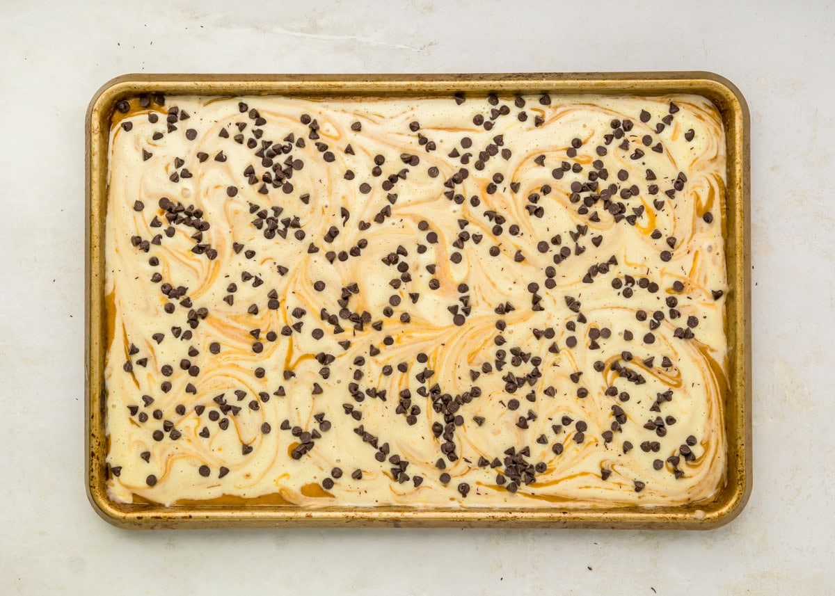 Mini chocolate chip sprinkled over bar mixture in pan.