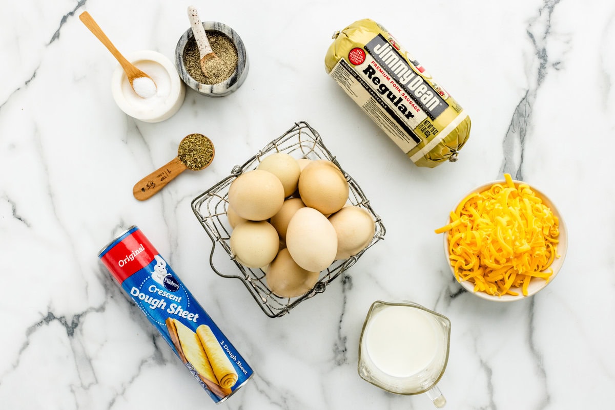 Eggs, sausage, and other ingredients on a kitchen counter.