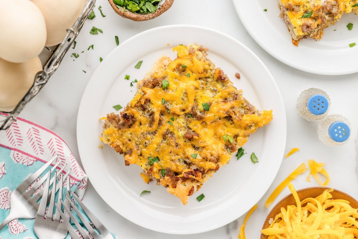 Sausage breakfast casserole sliced and served on a plate.